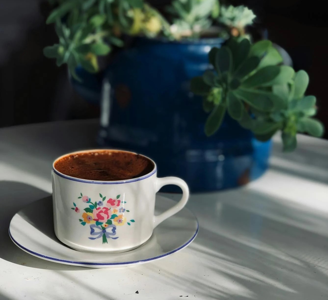 White cup with bouquet painted on it