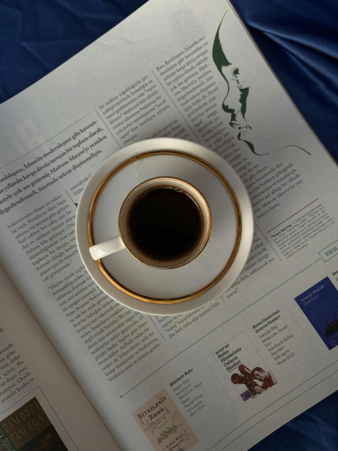 White cup with gold ring saucer