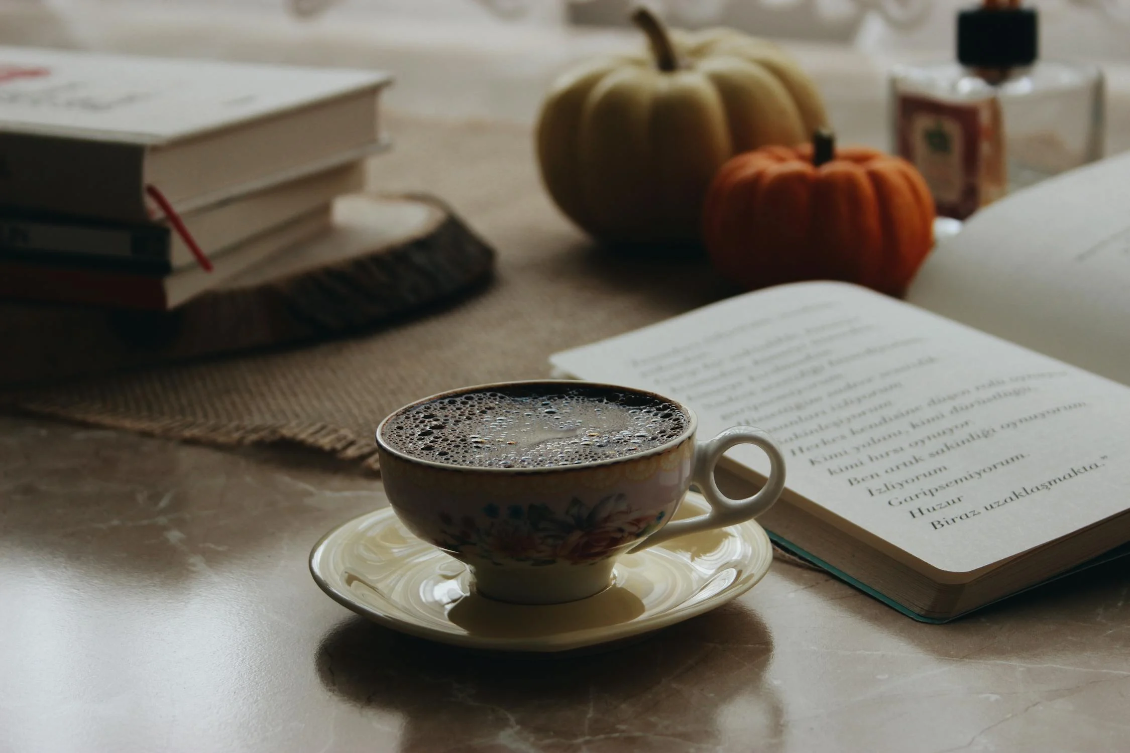 White cup with pumpkin feature