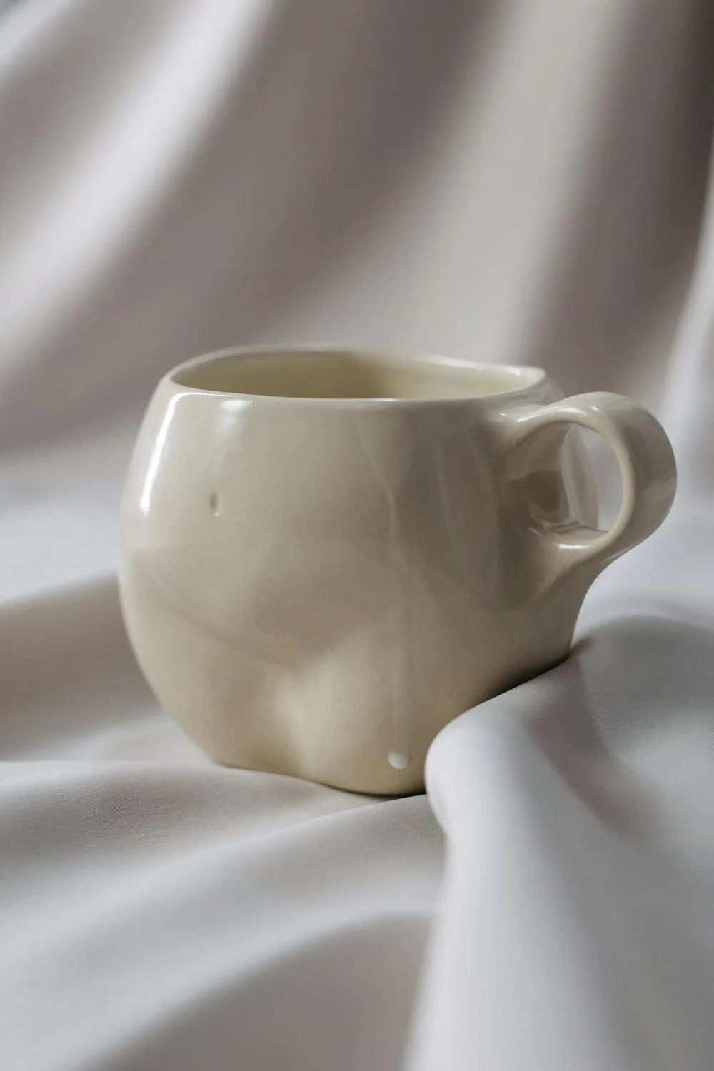 White ceramic cup inspired by women curves